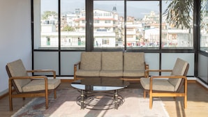 A living room with a sofa set, two armchairs, and a coffee table. - Hotel Norbu Sangpo (Kathmandu)