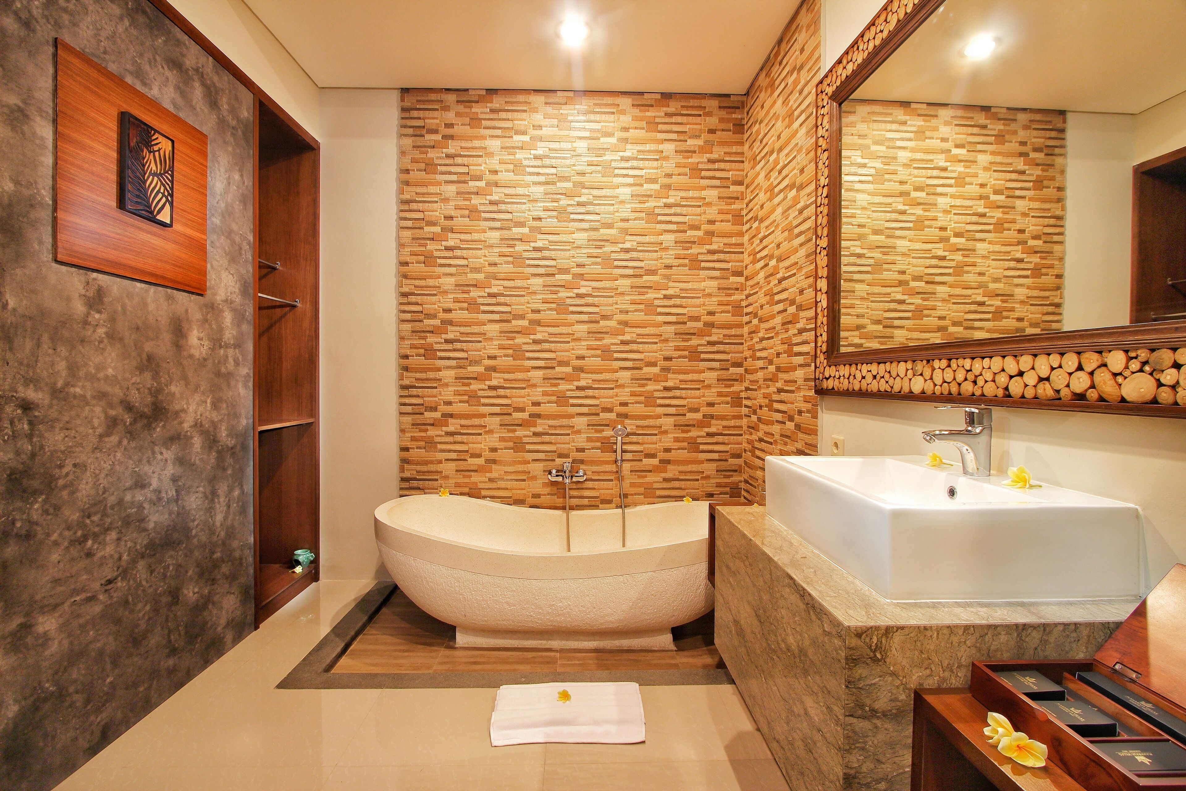 A modern bathroom with a freestanding bathtub, a sink, and a large mirror.