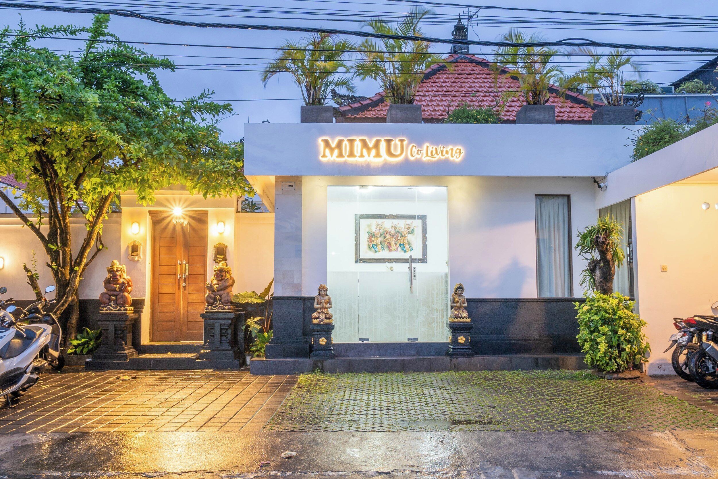 A two-story building with a sign reading "MIMU Co. Living".