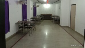 A conference room with tables and chairs arranged for meetings. - Hotel Aicon Palace (Agra)