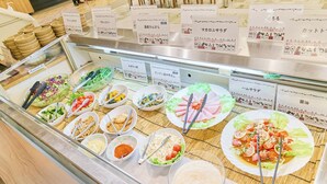 A buffet with various dishes and condiments.