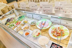 A buffet with various dishes and condiments.