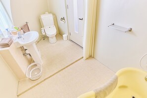 A bathroom with a sink, toilet, and bathtub.