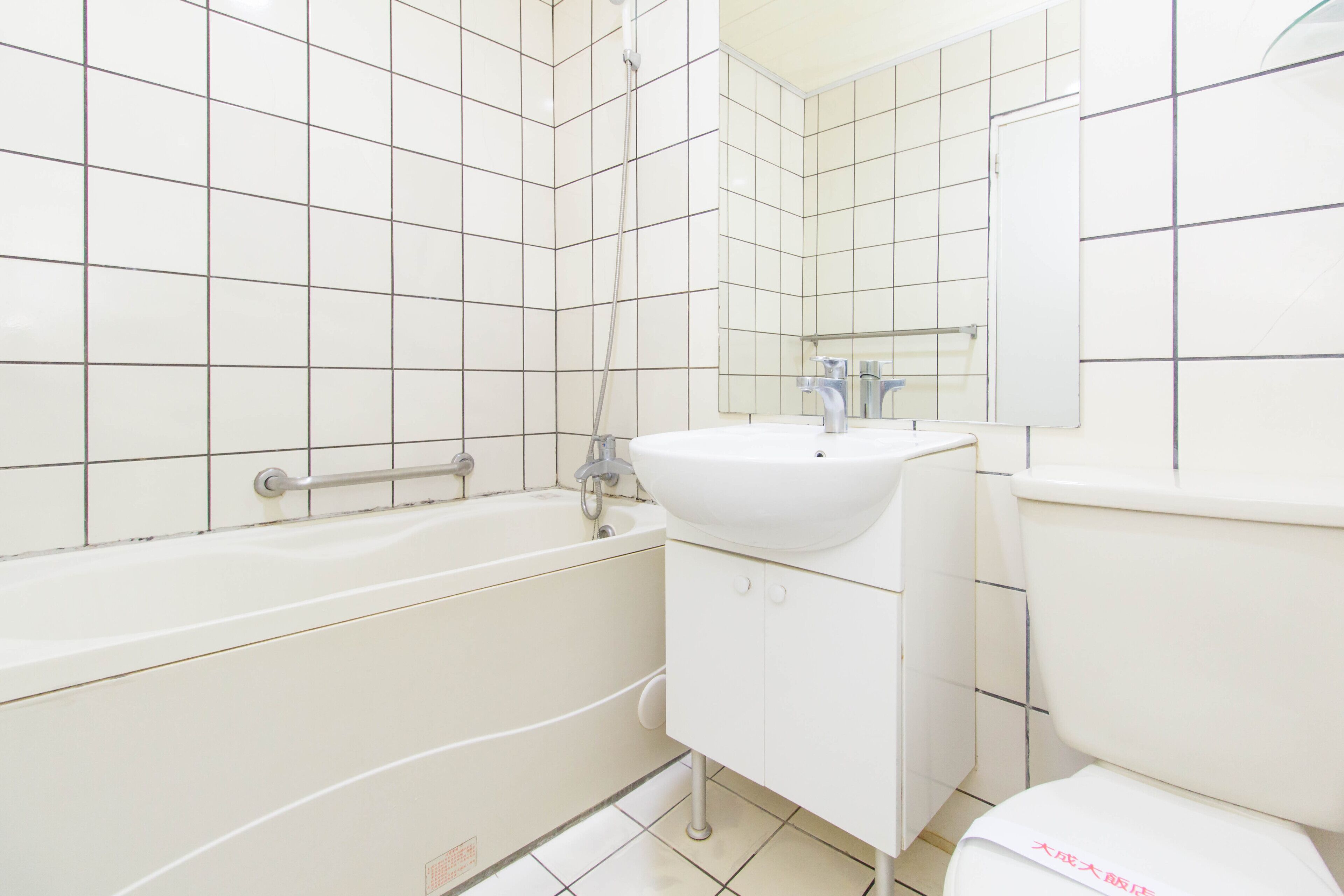 A bathroom with a bathtub, sink, and toilet.
