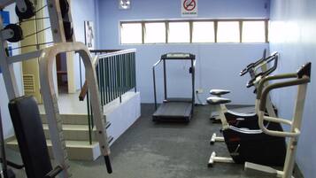 A gym with treadmills, weight machines, and a stair climber.