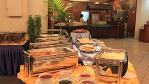 A buffet setup with various food items and serving utensils. - Bayu Beach Resort (Port Dickson)