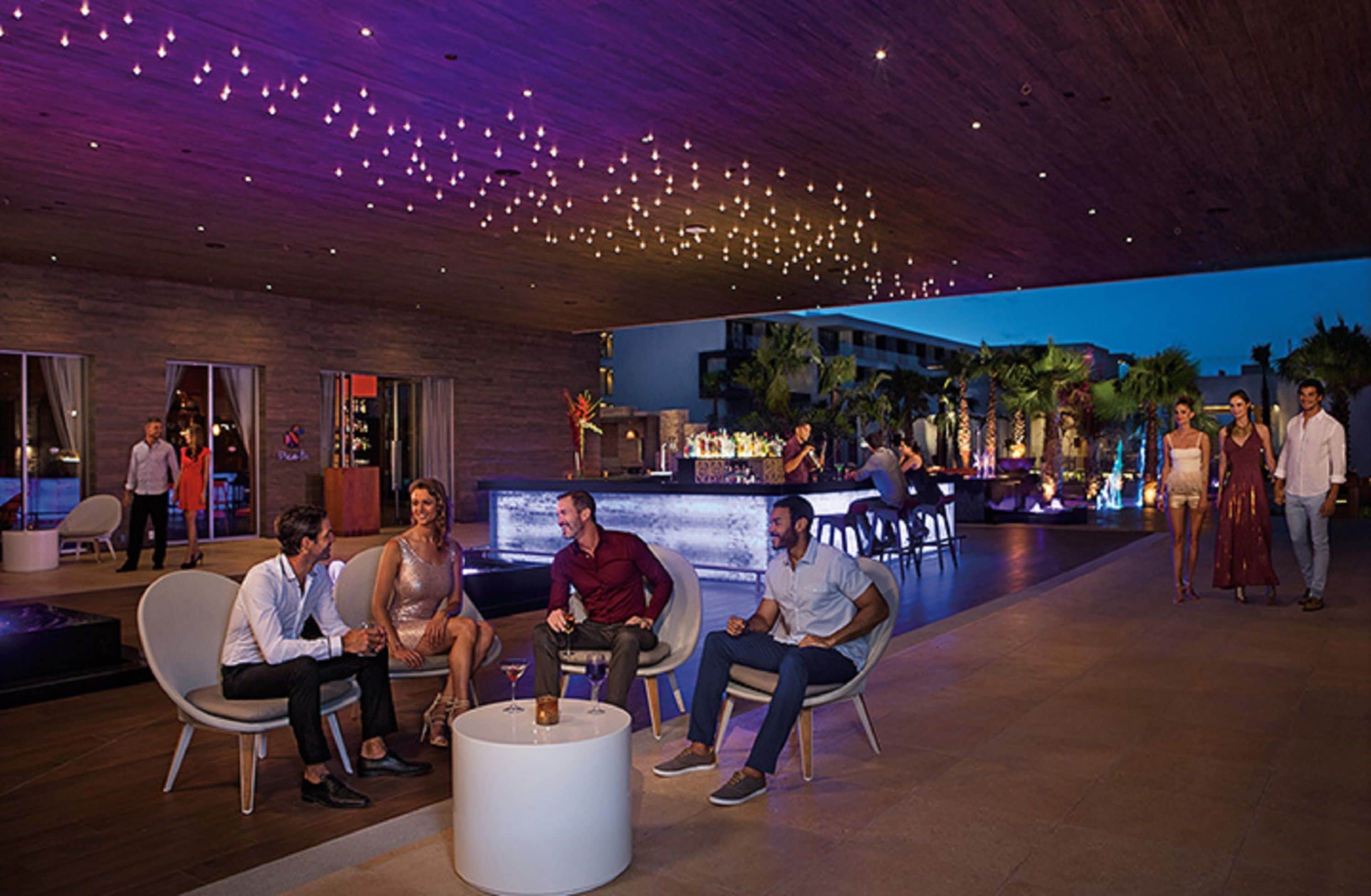 A modern indoor area with seating arrangements and a bar area.