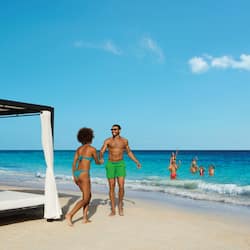 On the beach, white sand, sun loungers, beach umbrellas