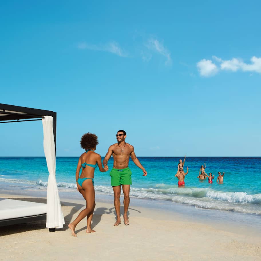 On the beach, white sand, sun loungers, beach umbrellas