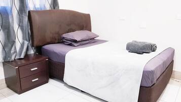 Desk, iron/ironing board, bed sheets