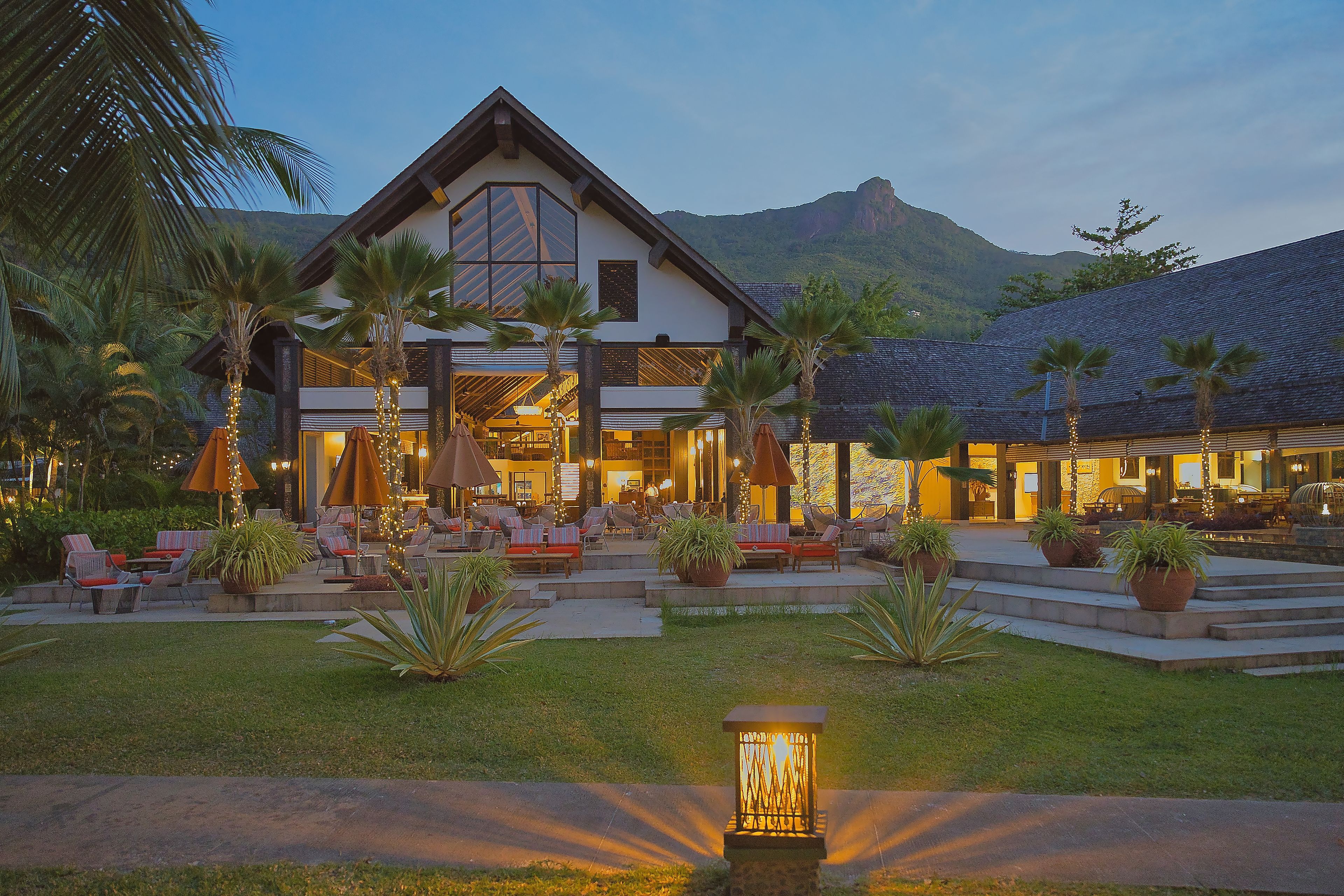 A large resort with multiple dining areas, outdoor seating, and a well-maintained garden.