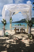 On the beach, white sand, sun-loungers, beach towels