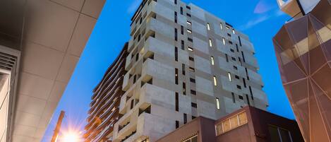 A high-rise building with multiple floors, large windows, and a modern architectural design.