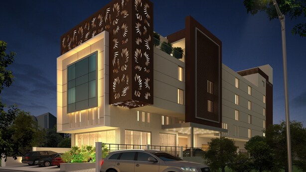 Un hotel moderno con una amplia fachada de vidrio, un diseño decorativo con motivos de hojas y una entrada bien iluminada.