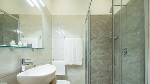 A modern bathroom with a glass-enclosed shower, a white sink, and a toilet. - Hotel Bella Napoli (Naples)
