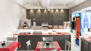 A breakfast bar with various food items and a LILIA refrigerator. - Hotel Bella Napoli (Naples)