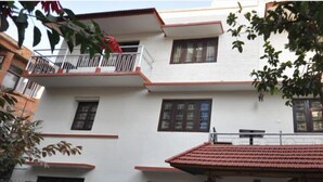 A multi-story building with a balcony on the second floor. - Hotel Peace N Park (Kathmandu)