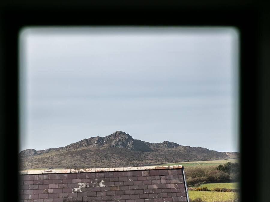 Un paysage de montagne avec un bâtiment en briques au premier plan.