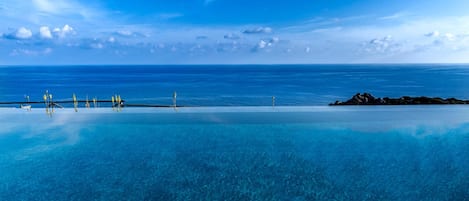 Outdoor pool, an infinity pool, pool loungers