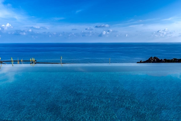 Outdoor pool, an infinity pool, pool loungers
