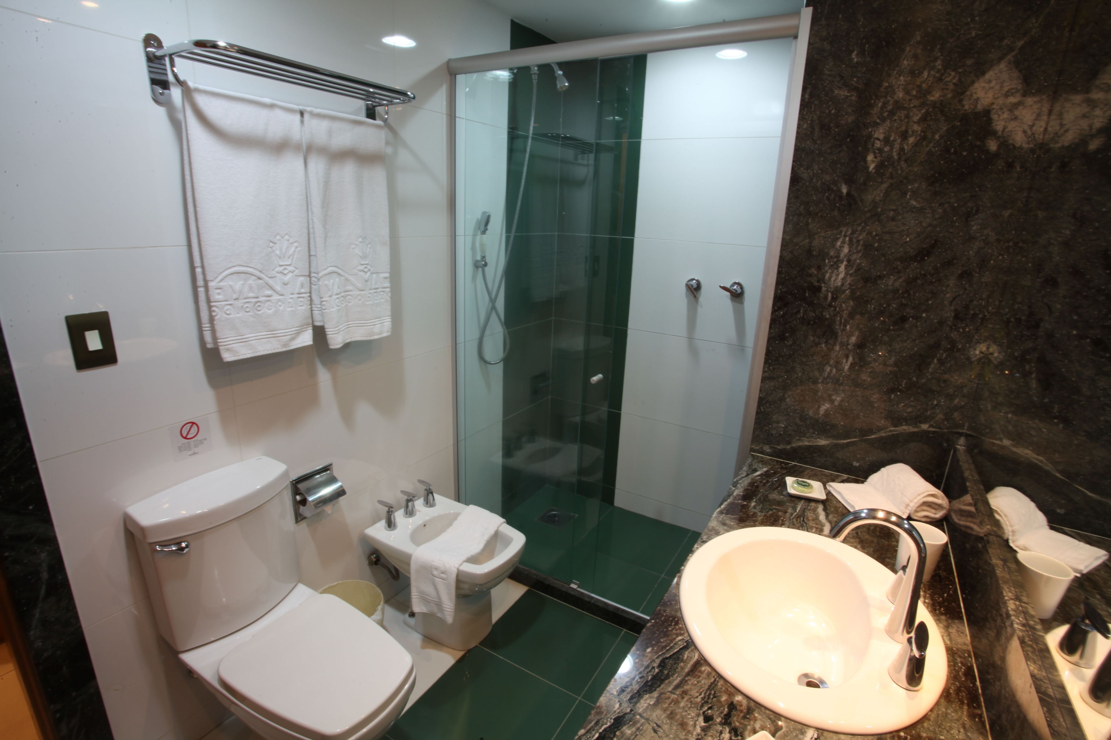 designer toiletries, hair dryer, towels