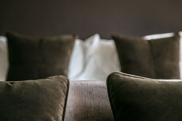 A close-up of a sofa with multiple cushions.