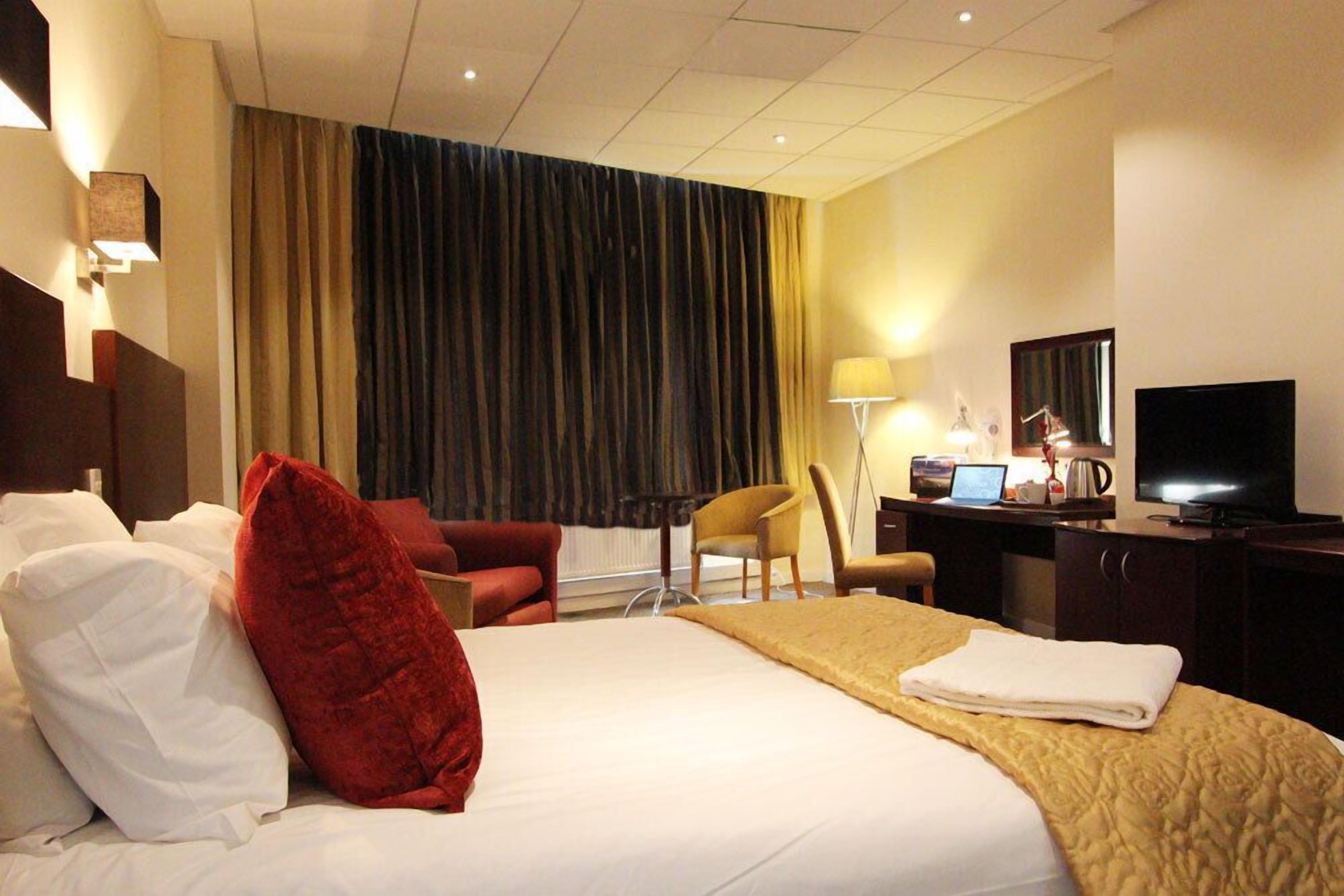 Ropa de cama de alta calidad y caja de seguridad en la habitación 