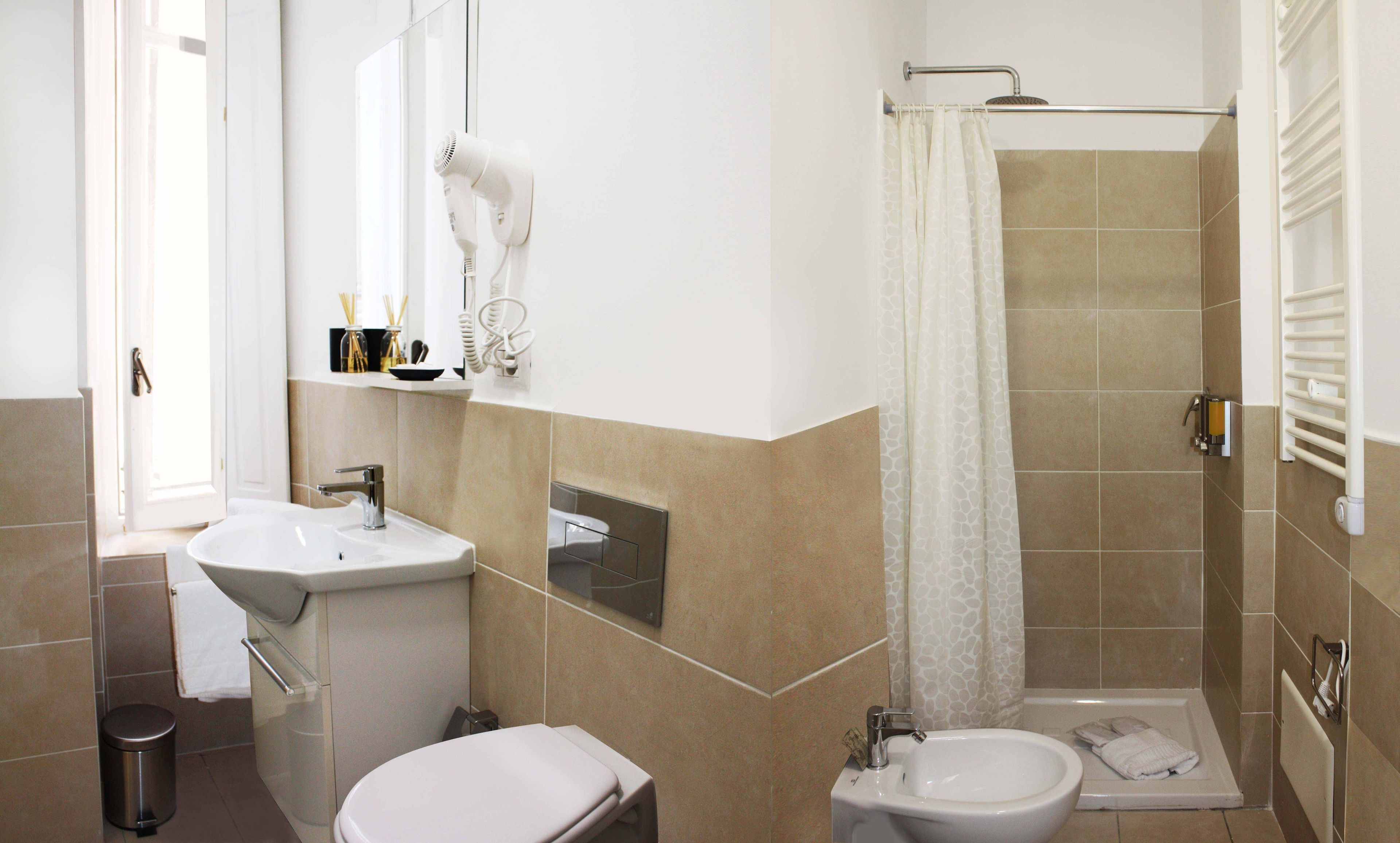 A bathroom with a sink, toilet, and shower.