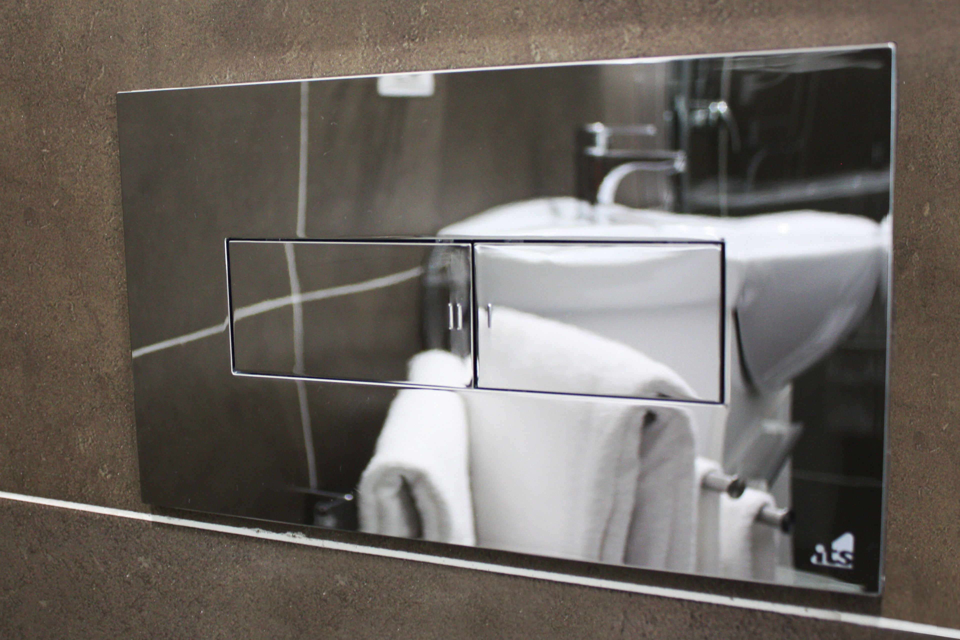 A bathroom with a modern sink and mirror.