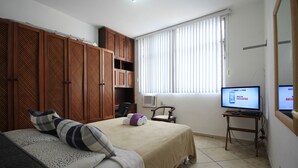 A hotel room with a bed, a TV, a desk, and a wardrobe. - Copacabana 705 B (Rio de Janeiro)