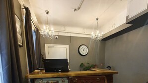 A room with a desk, a clock, and a wall-mounted radiator. - Birka Hotel (Stockholm)