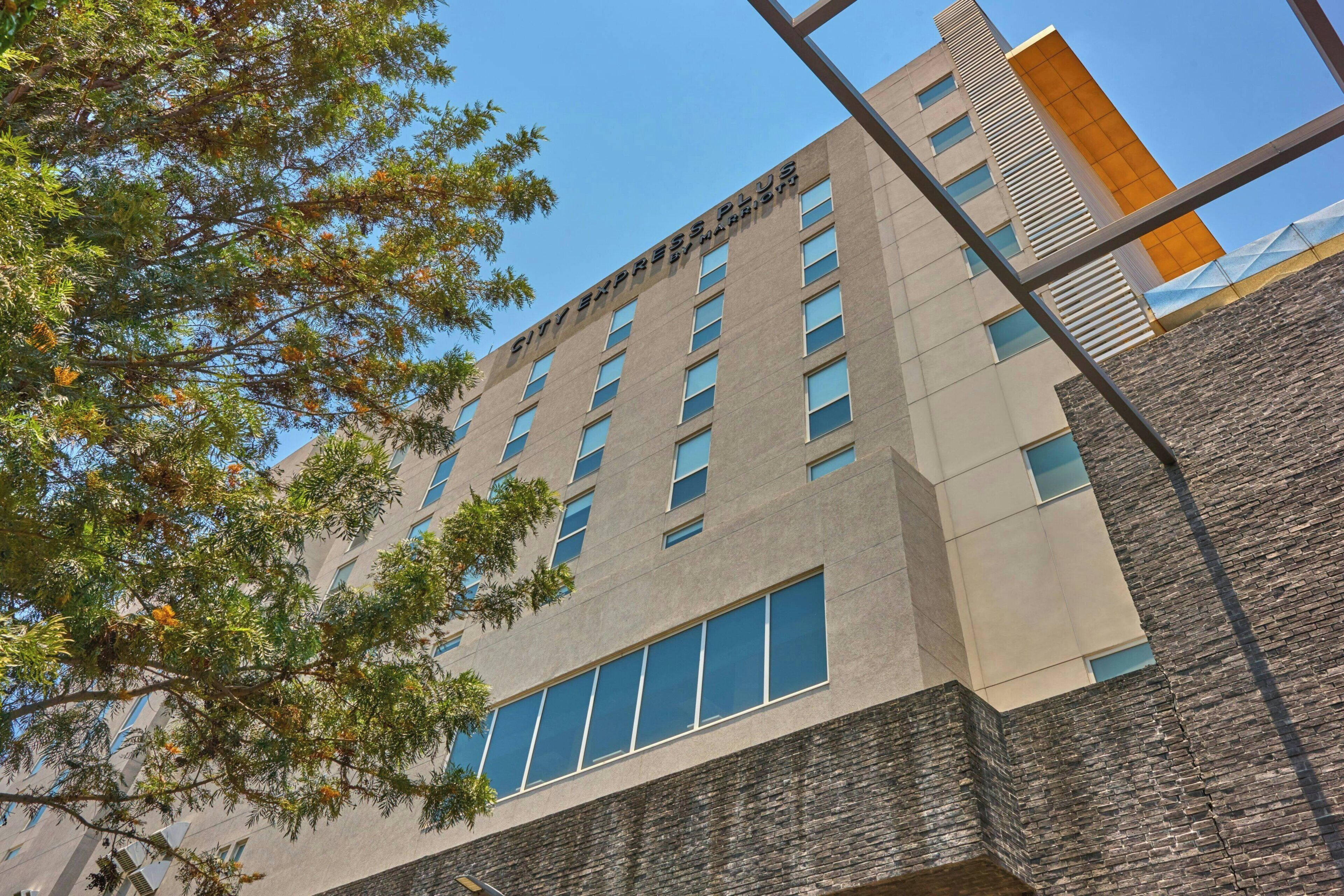 A multi-story building with a flat facade, large windows, and a visible entrance.