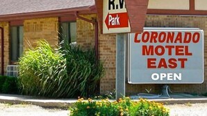A motel sign with 'CORONADO MOTEL EAST' and 'OPEN' indicating the establishment is operational. - Coronado Motel and RV Park (Lindsborg)