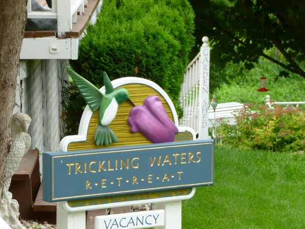 A sign for Trickle Waters Retreat with a vacancy notice. - Trickling Waters Retreat (Marquette)