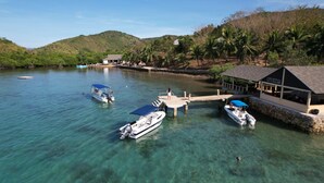 A clear view of a resort with a dock, boats, and a building labeled "CHINOVAN DIVE RESORT".