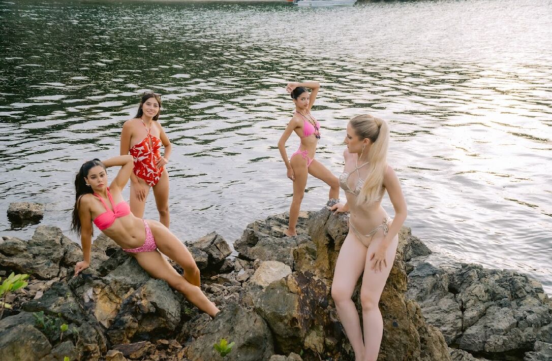 A group of people on rocky terrain near a body of water.