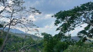 A swimming pool with a view of a lush landscape and mountains in the background. - Nam Ou Riverside Hotel & Resort (Pak Ou)