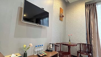 Family Twin Room | Living area | Flat-screen TV