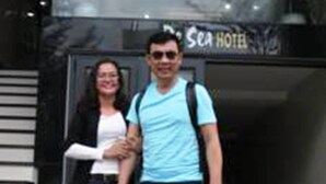 A man and a woman standing in front of a building with a sign that reads "Sea Hotel". - BeSea Hotel Da Nang (Da Nang)