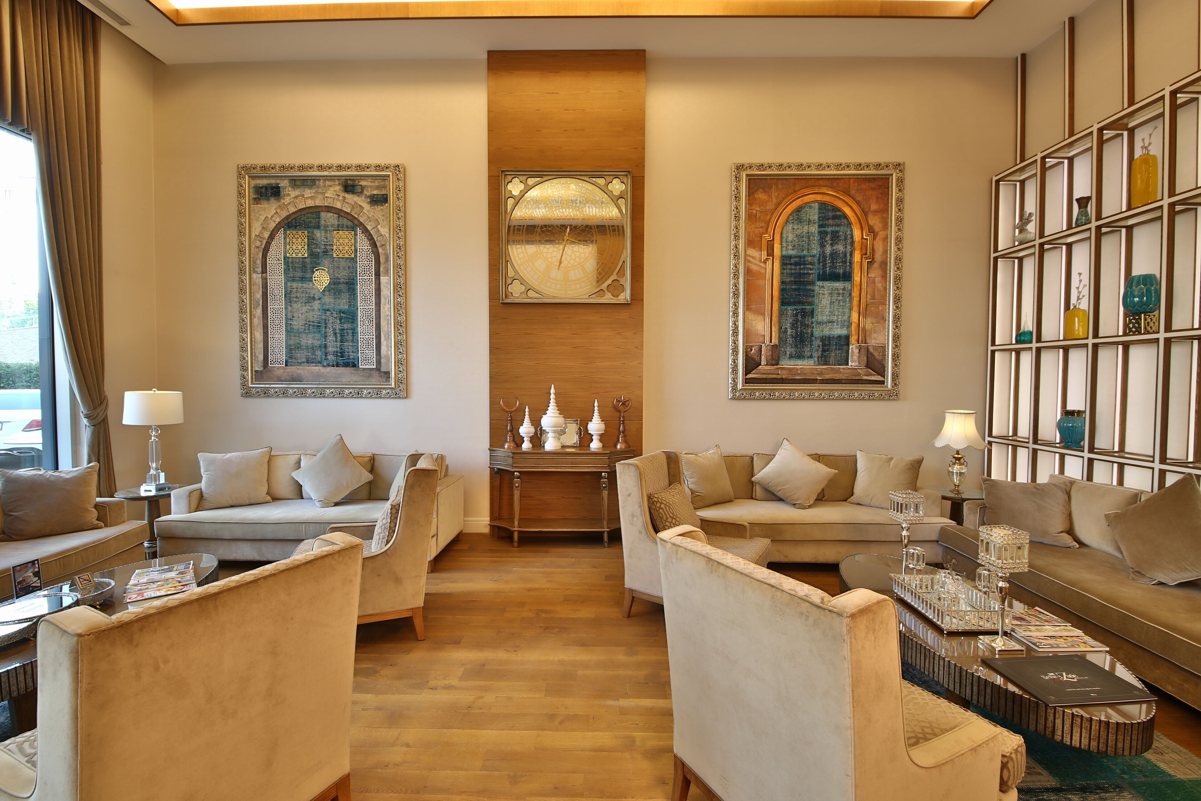 A spacious living room with a wooden floor, two sofas, a coffee table, and a bookshelf.