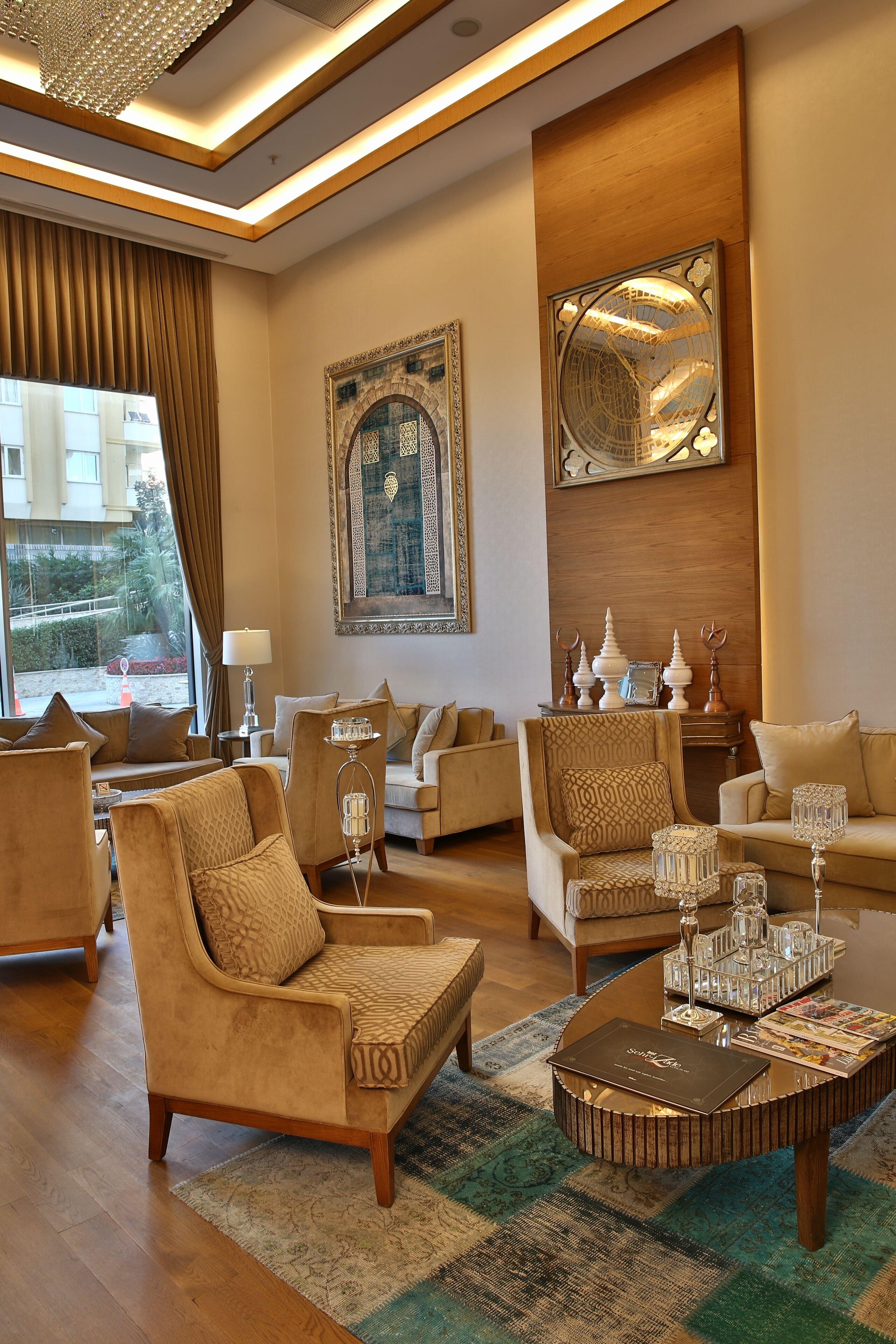 A spacious living room with multiple seating areas, a coffee table with decorative items, and a large wall mirror.