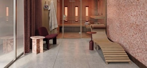 A spa area with a sauna, seating, and a glass partition.