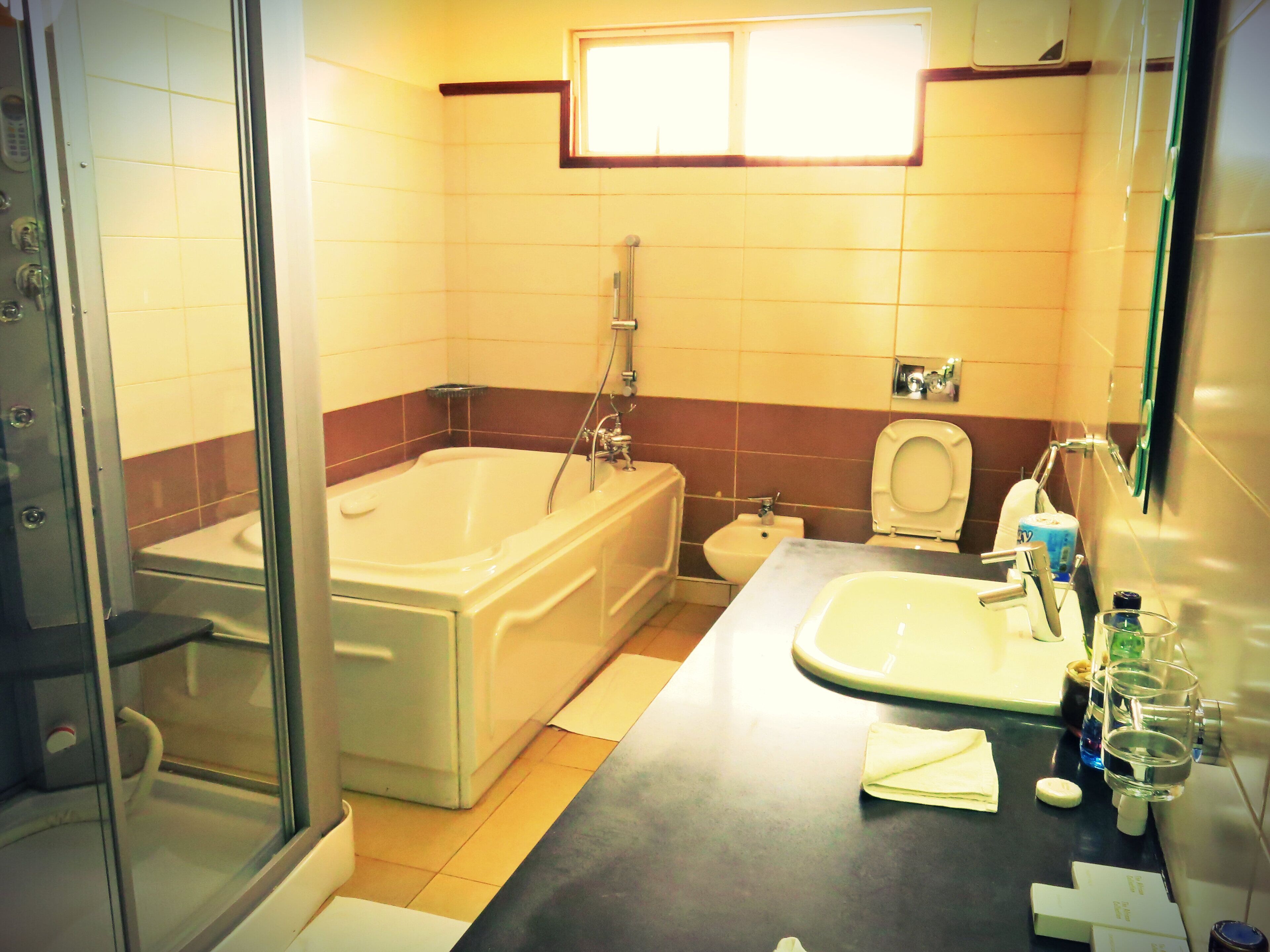 A bathroom with a bathtub, toilet, and sink.