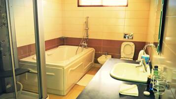 A bathroom with a bathtub, toilet, and sink.