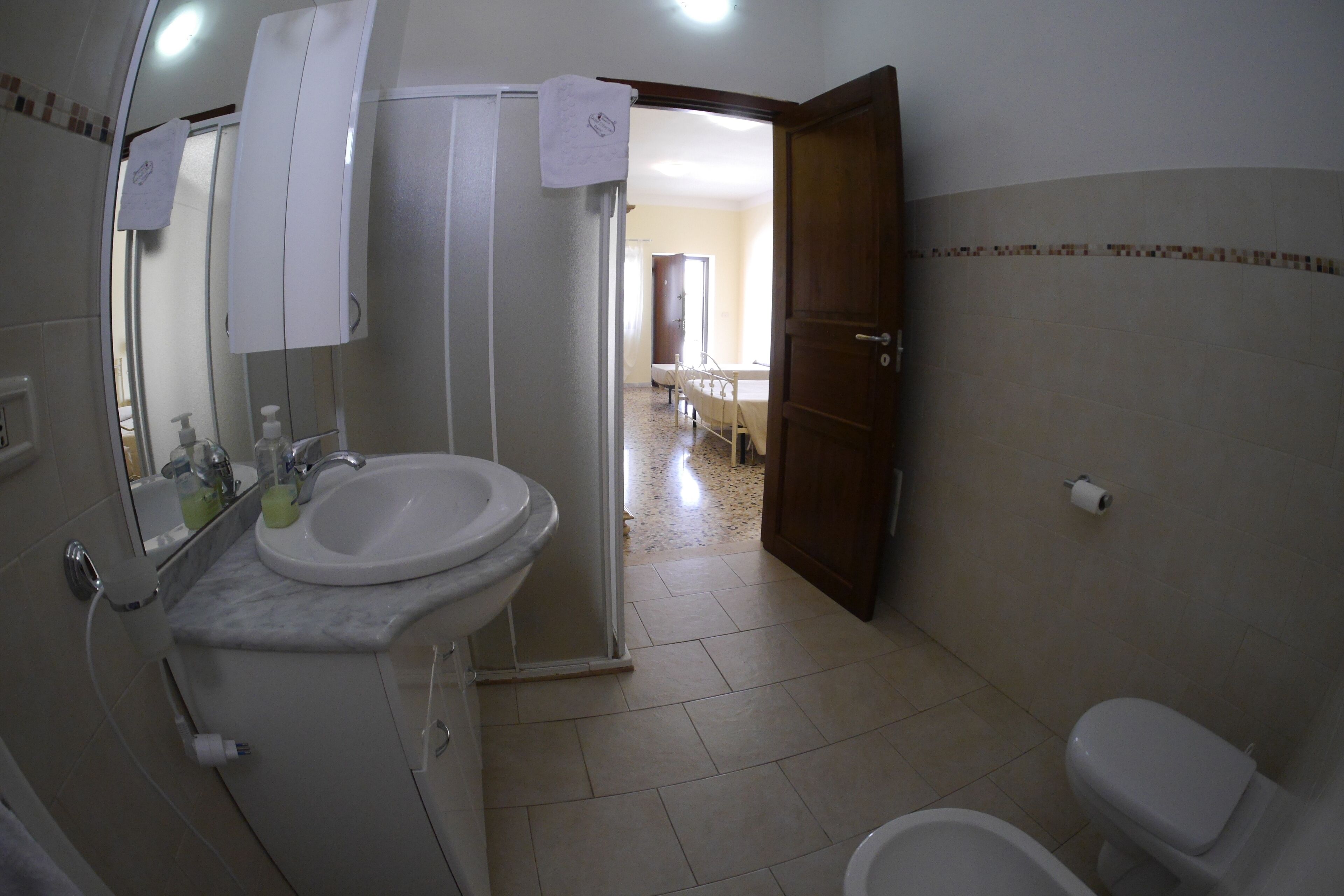 A bathroom with a sink, mirror, and toilet.