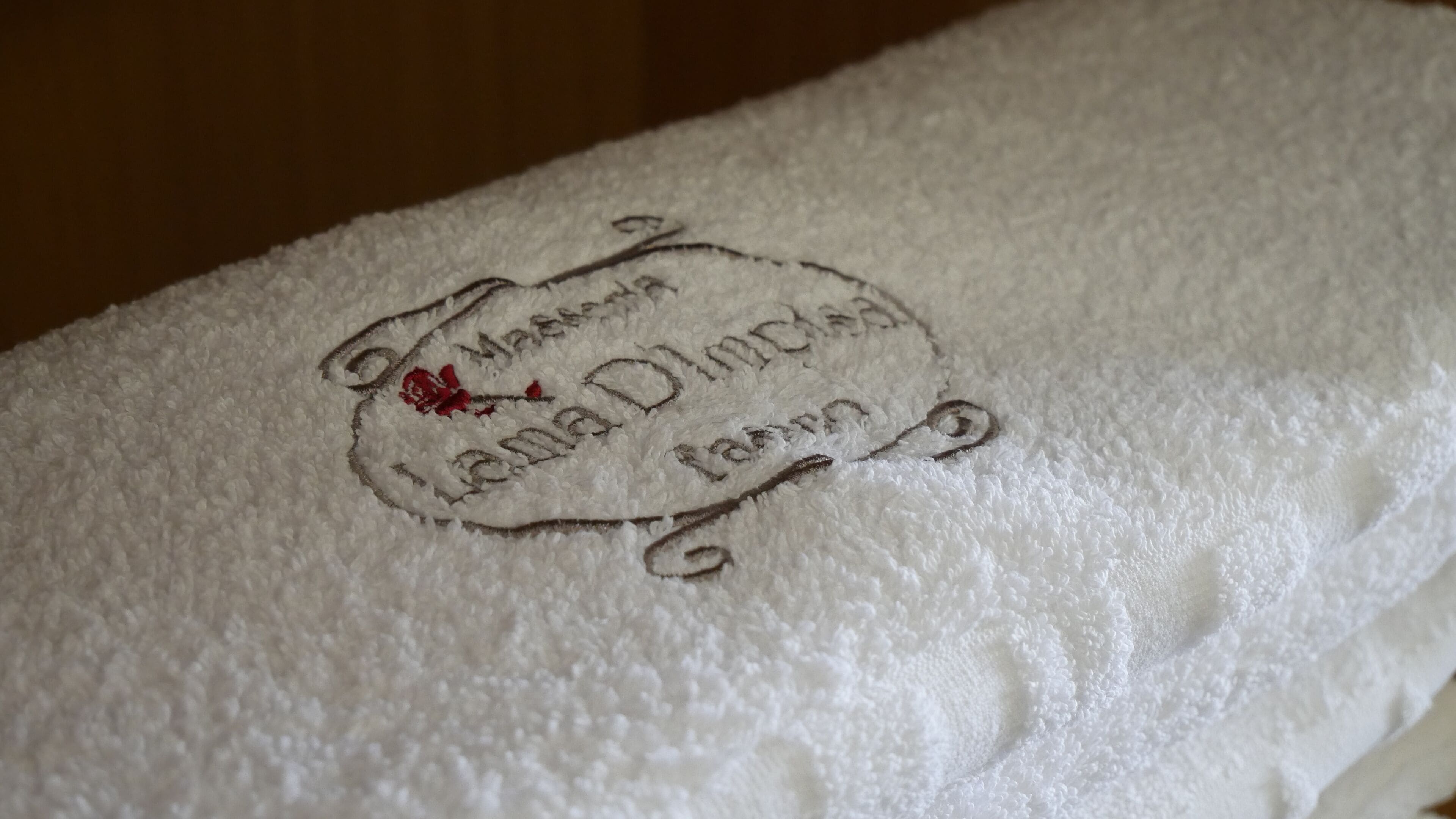 A white towel with embroidered text.