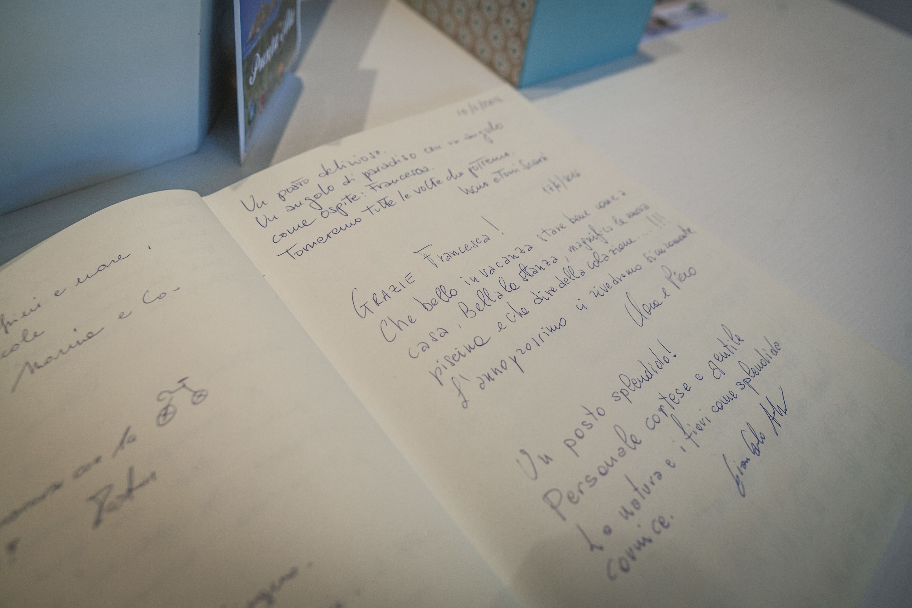 An open notebook with handwritten text in Italian, possibly a journal or notes.