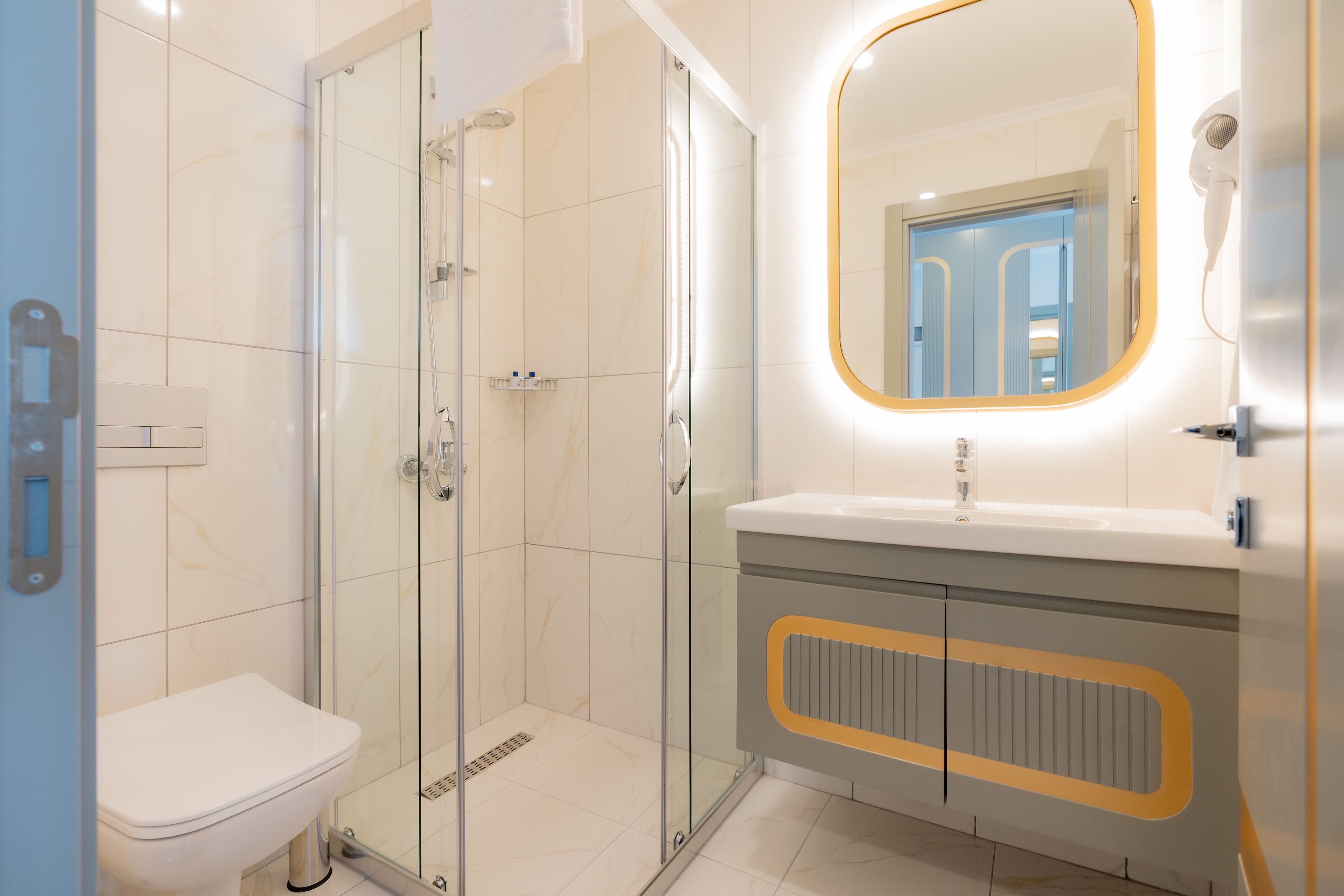 shower, hair dryer, slippers, towels