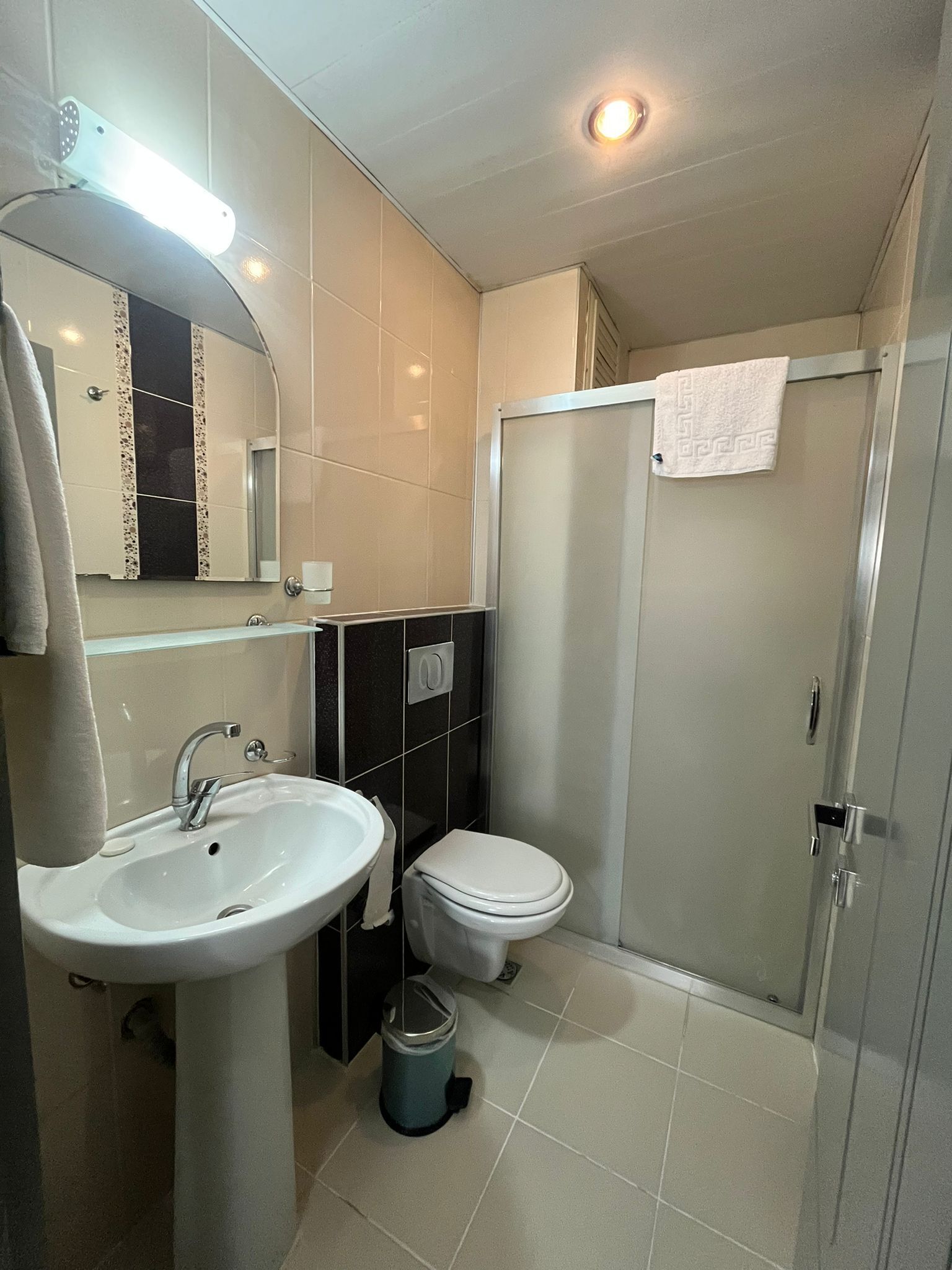 shower, hair dryer, slippers, towels