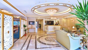A luxurious lobby with a grand chandelier, elegant seating, and a reception desk. - Hotel Emirhan Palace (Istanbul)